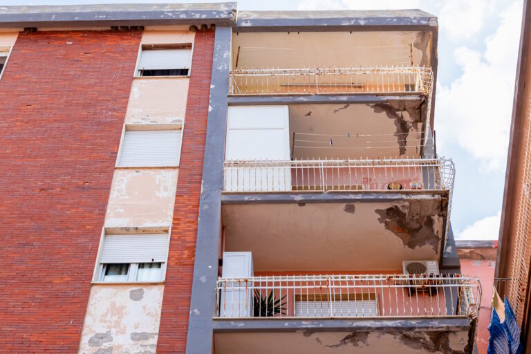 Balconies with cracked concrete and rusty irons requiring renova